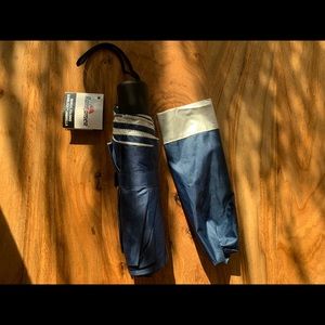 Raintamer Manual Folding Sunblock Umbrella. 10” collapsed and closed. Brand new